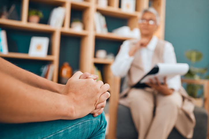 woman with depression, trauma, or stress speaking to psychiatrist